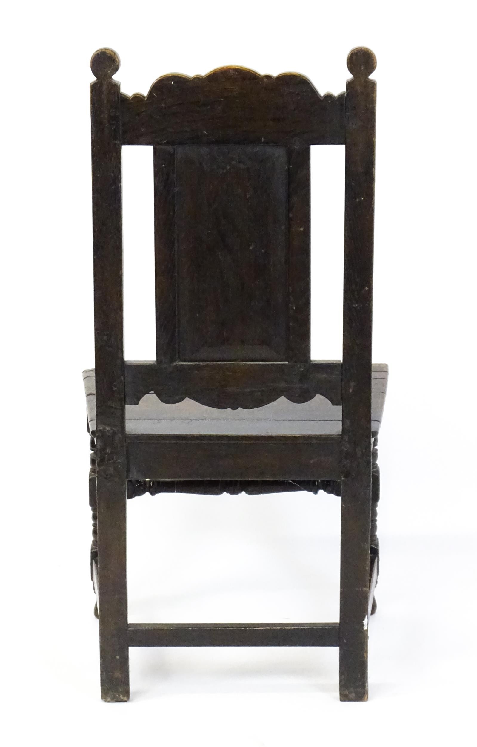 A 19thC carved oak side chair with floral carving, a planked seat and raised on block and turned - Image 6 of 6