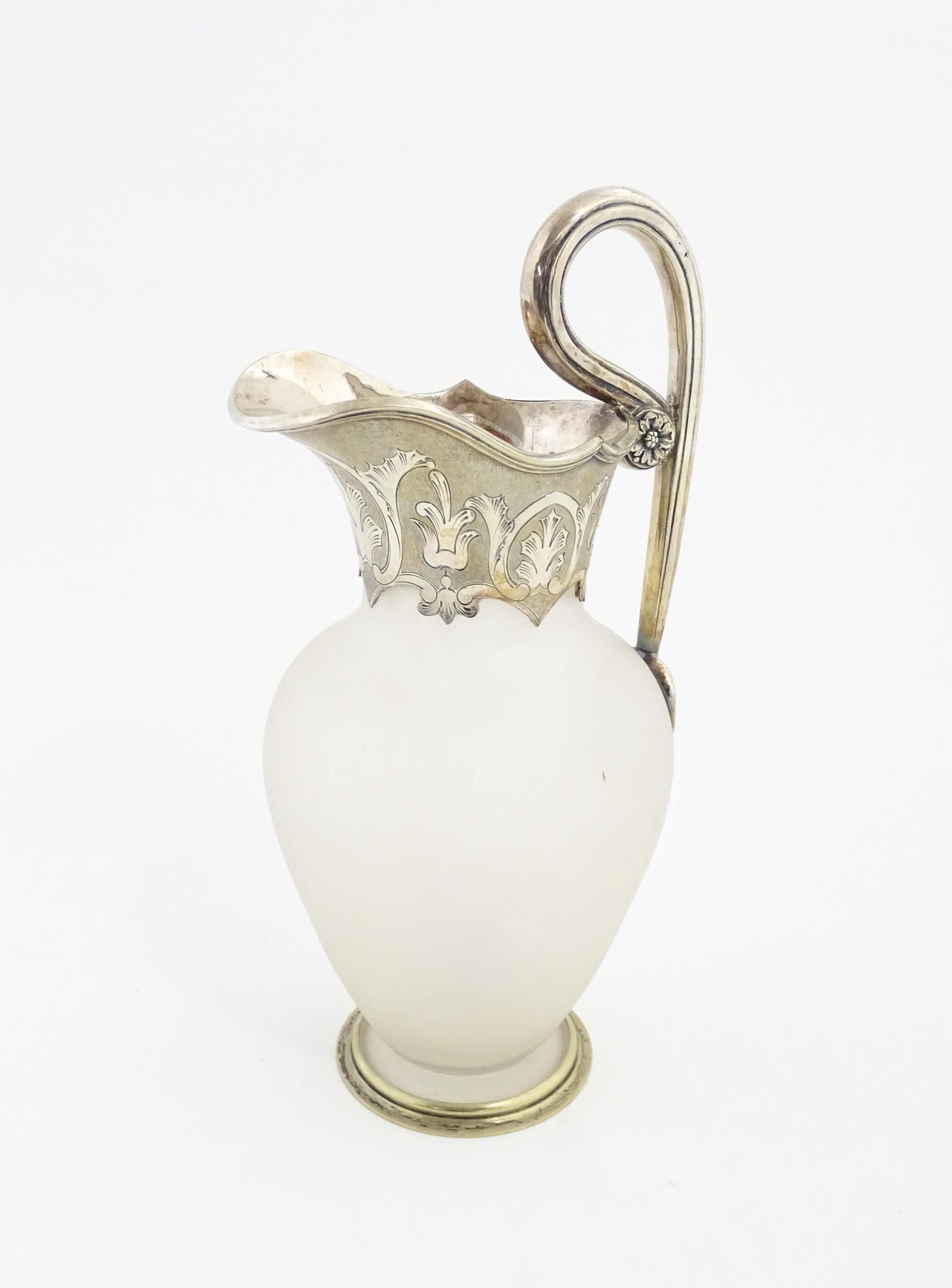 A Victorian frosted glass jug of ewer form with silver plate handle and mounts. Approx. 11 1/2" high