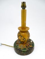 A 20thC turned wooden table lamp with painted detail depicting Mount Fuji, pagoda style buildings,