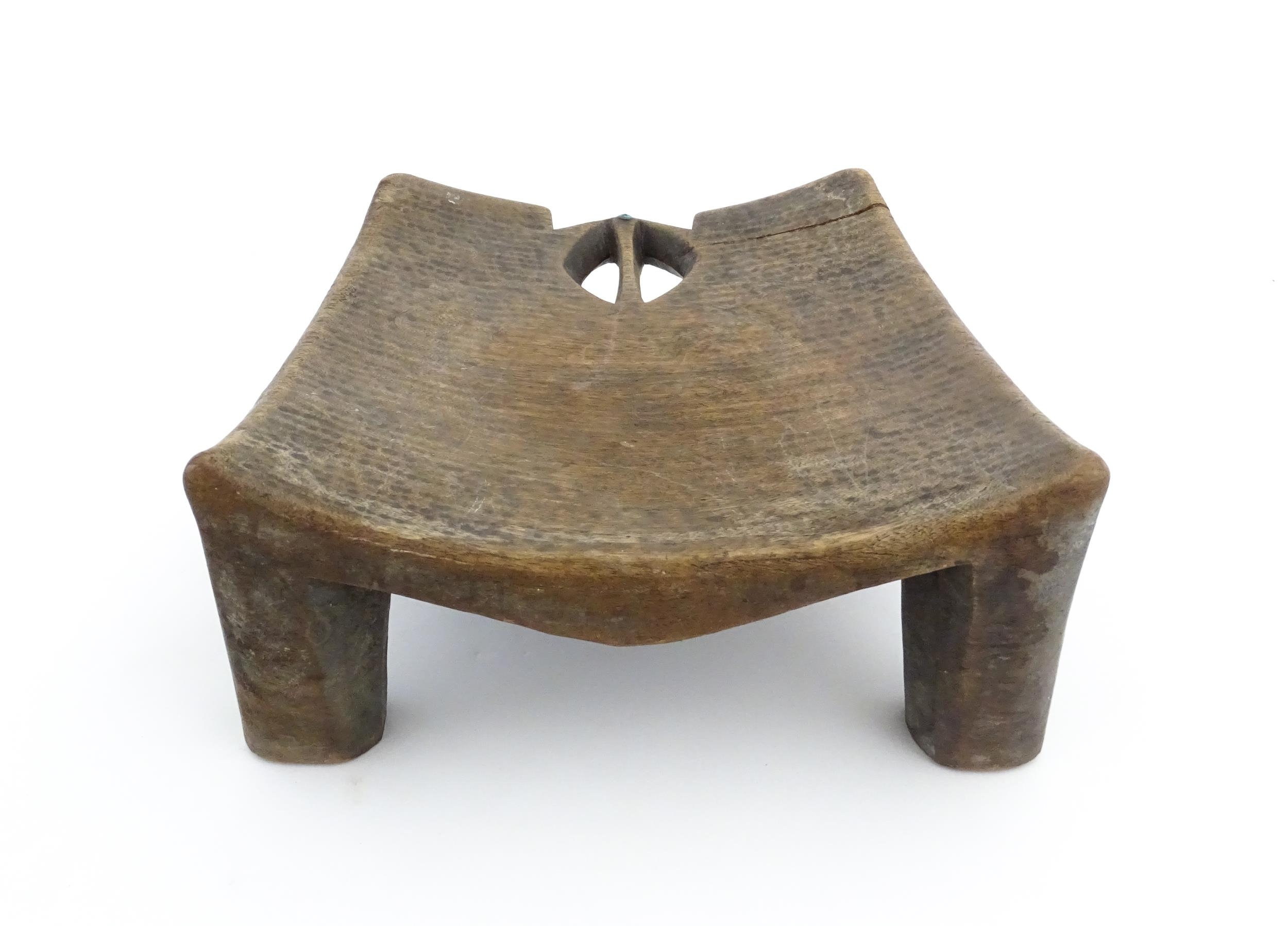 Ethnographic / Native / Tribal: An African carved wooden stool with pierced decoration, raised on - Image 5 of 7