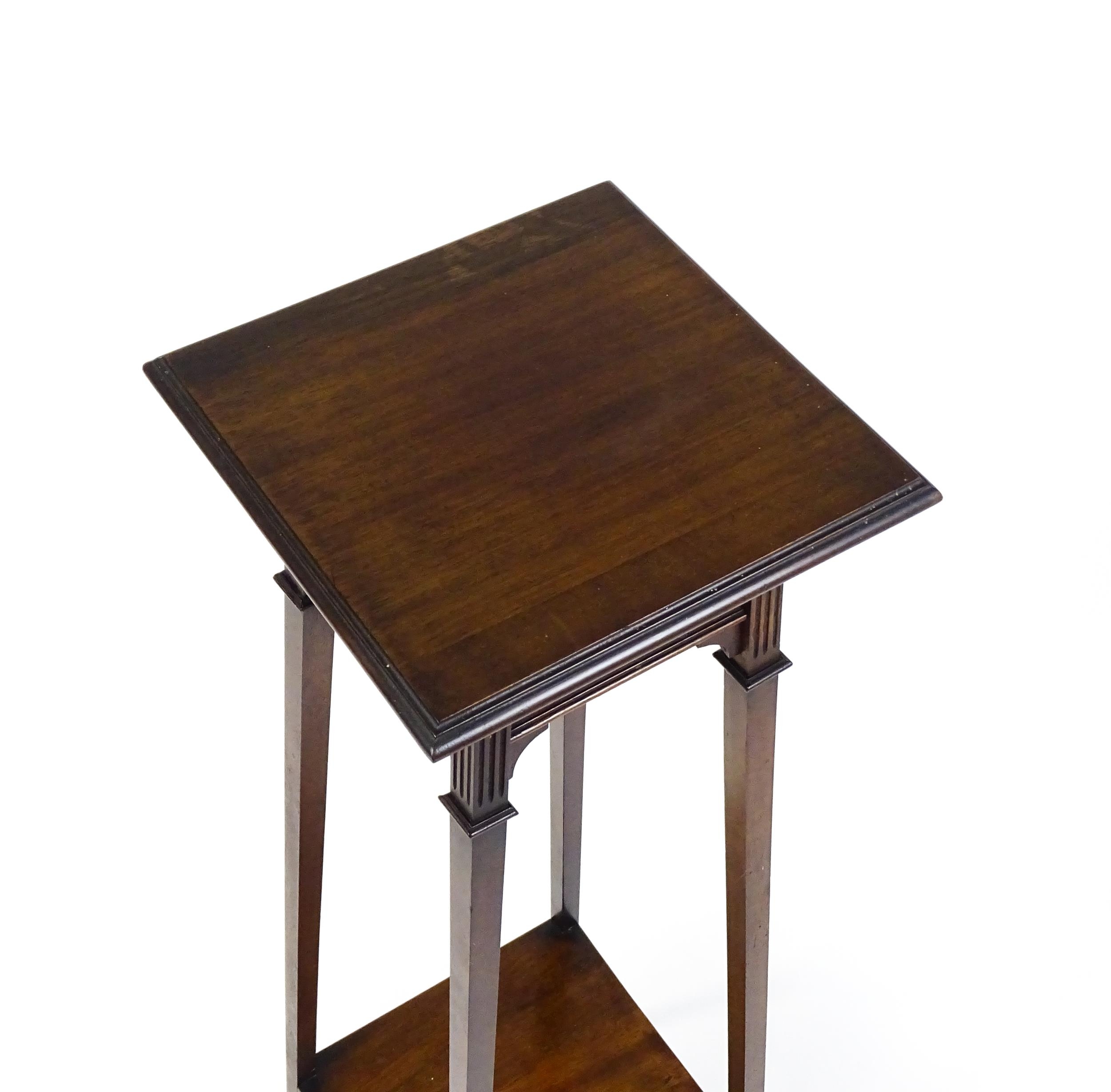 An early / mid 20thC mahogany jardinière stand with a moulded top above a fluted frieze raised on - Image 5 of 7