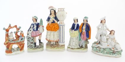 A quantity of Staffordshire pottery figures to include a girl holding a parrot, two figures above