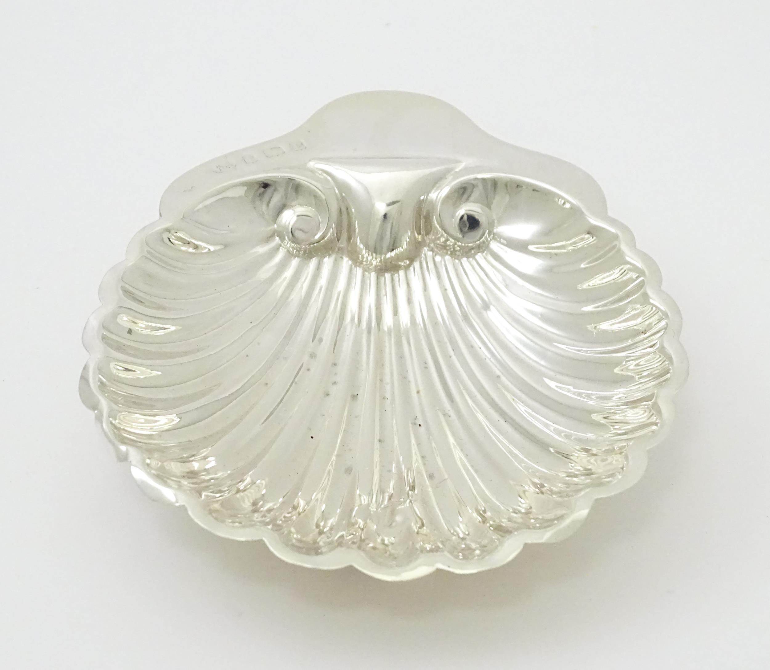 A silver butter dish of scallop shell form hallmarked Birmingham 1902, maker William Aitken. Approx. - Image 6 of 7