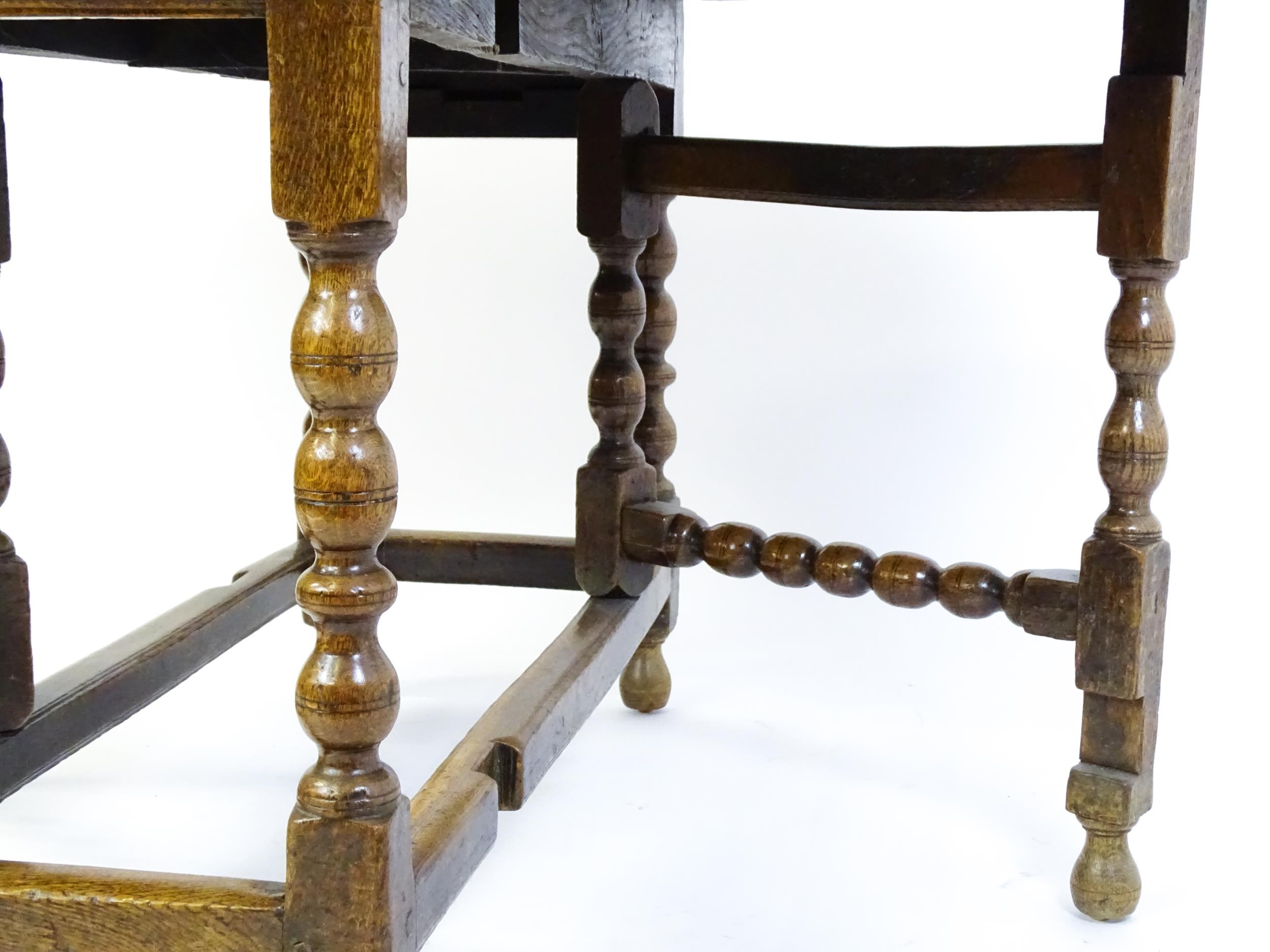 An early 18thC oak drop leaf table of large proportions, the table having two demi lune leaves and - Image 5 of 6