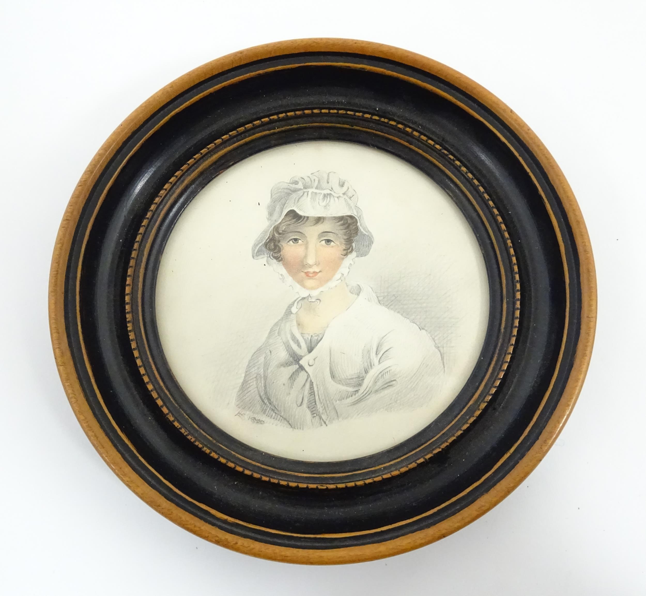A 19thC pencil and watercolour portrait miniature depicting a portrait of a young lady wearing a