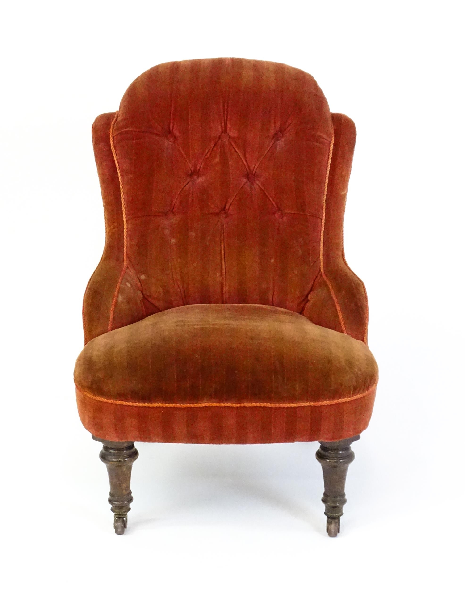 A late 19thC / early 20thC nursing chair with a deep buttoned backrest, sprung seat and raised on - Image 5 of 5