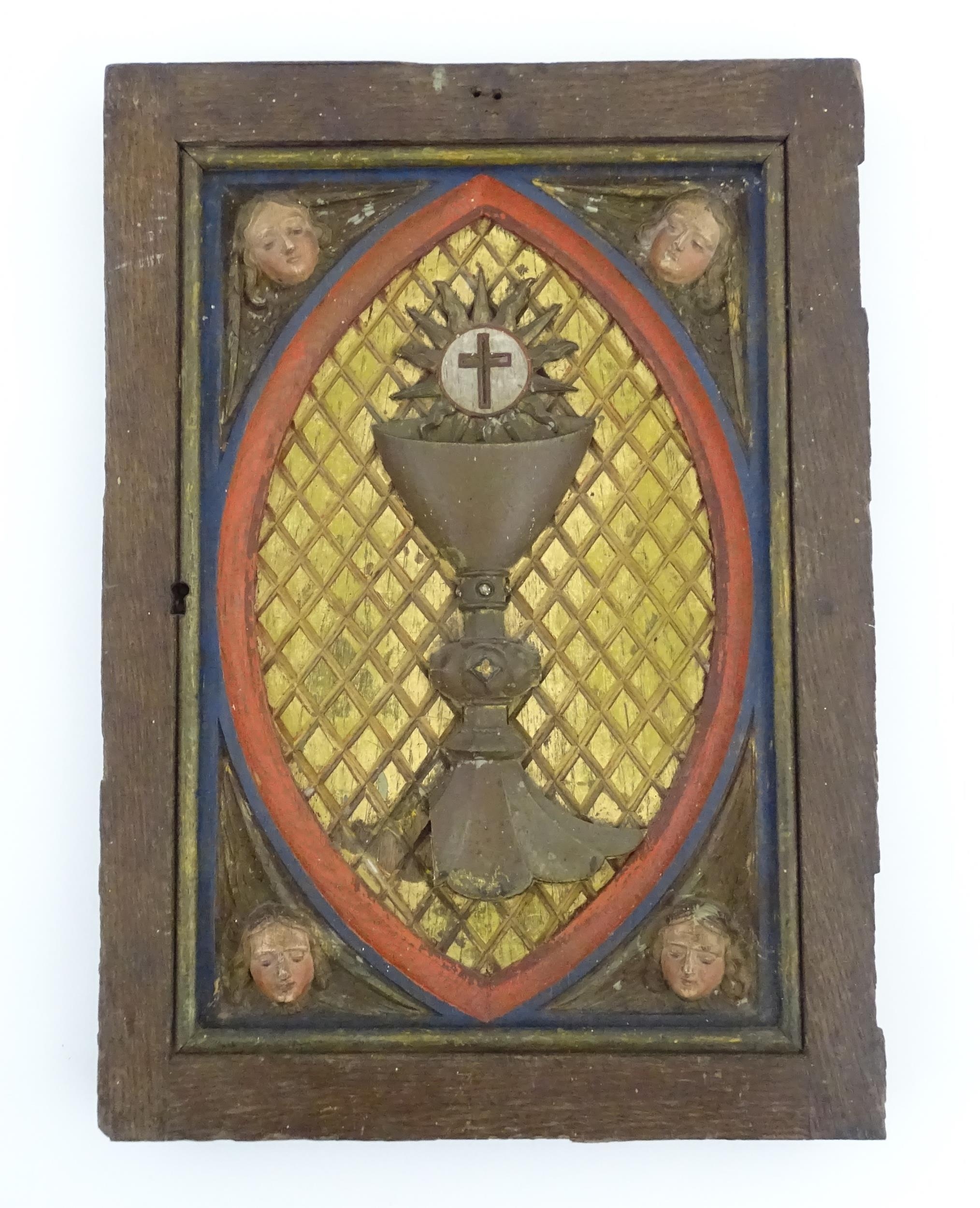 An early 20thC Continental tabernacle door with carved and polychrome decoration depicting a chalice