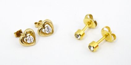 A pair of yellow metal stud earrings of heart form. Together with another pair. (2) Please Note - we