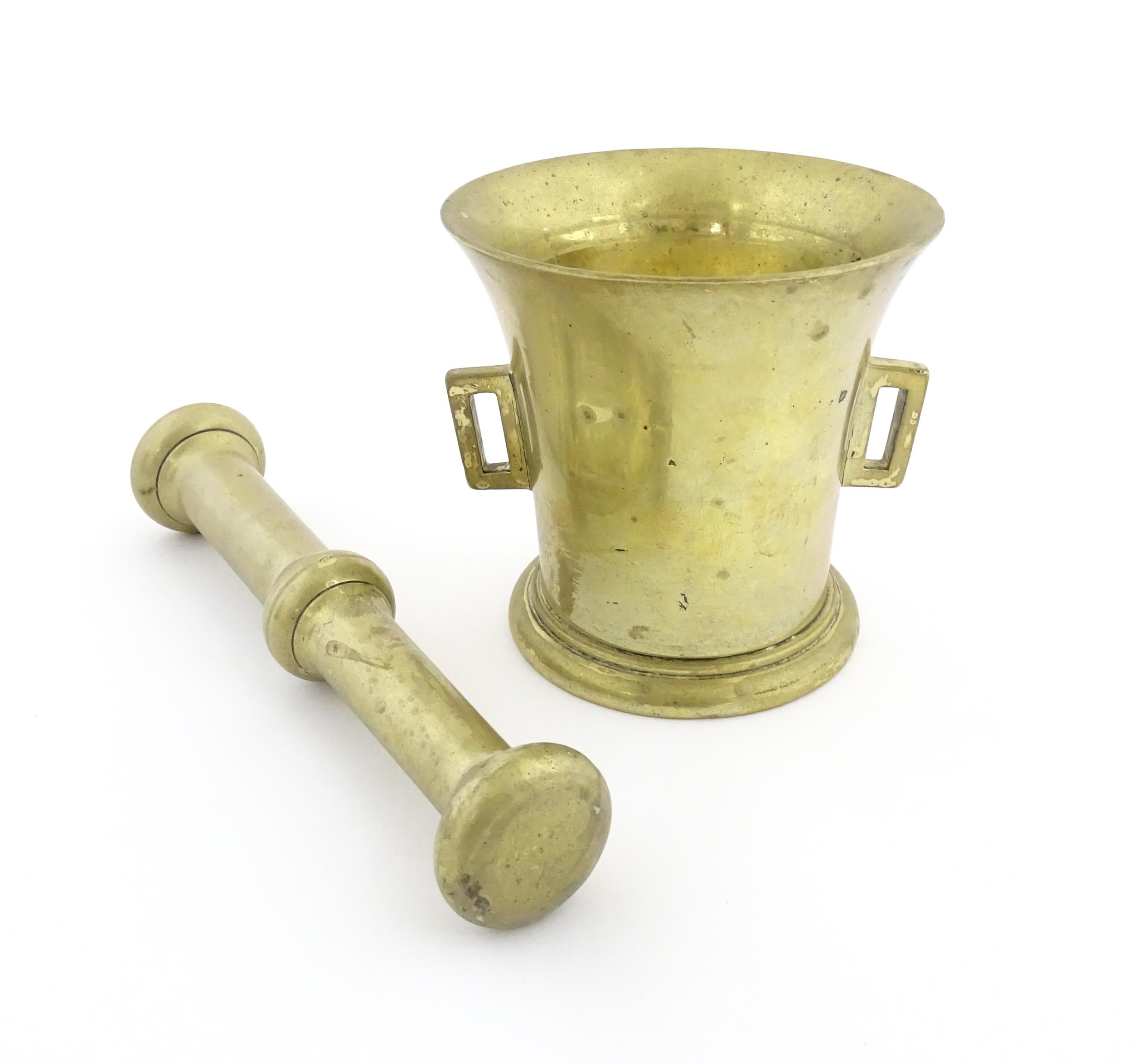 A 19thC brass pestle and mortar, the mortar of tapering form with twin rectangular handles. Mortar - Image 4 of 14