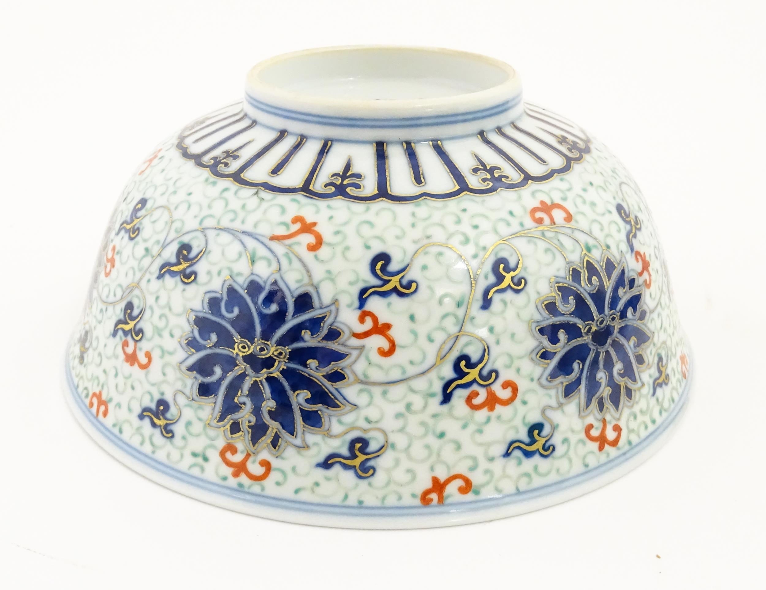 A Chinese bowl decorated with scrolling floral and foliate detail. Character marks under. Approx. 3" - Image 2 of 9