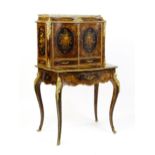 A 19thC kingwood Bonheur du jour surmounted by a brass gallery and having a profusely inlaid