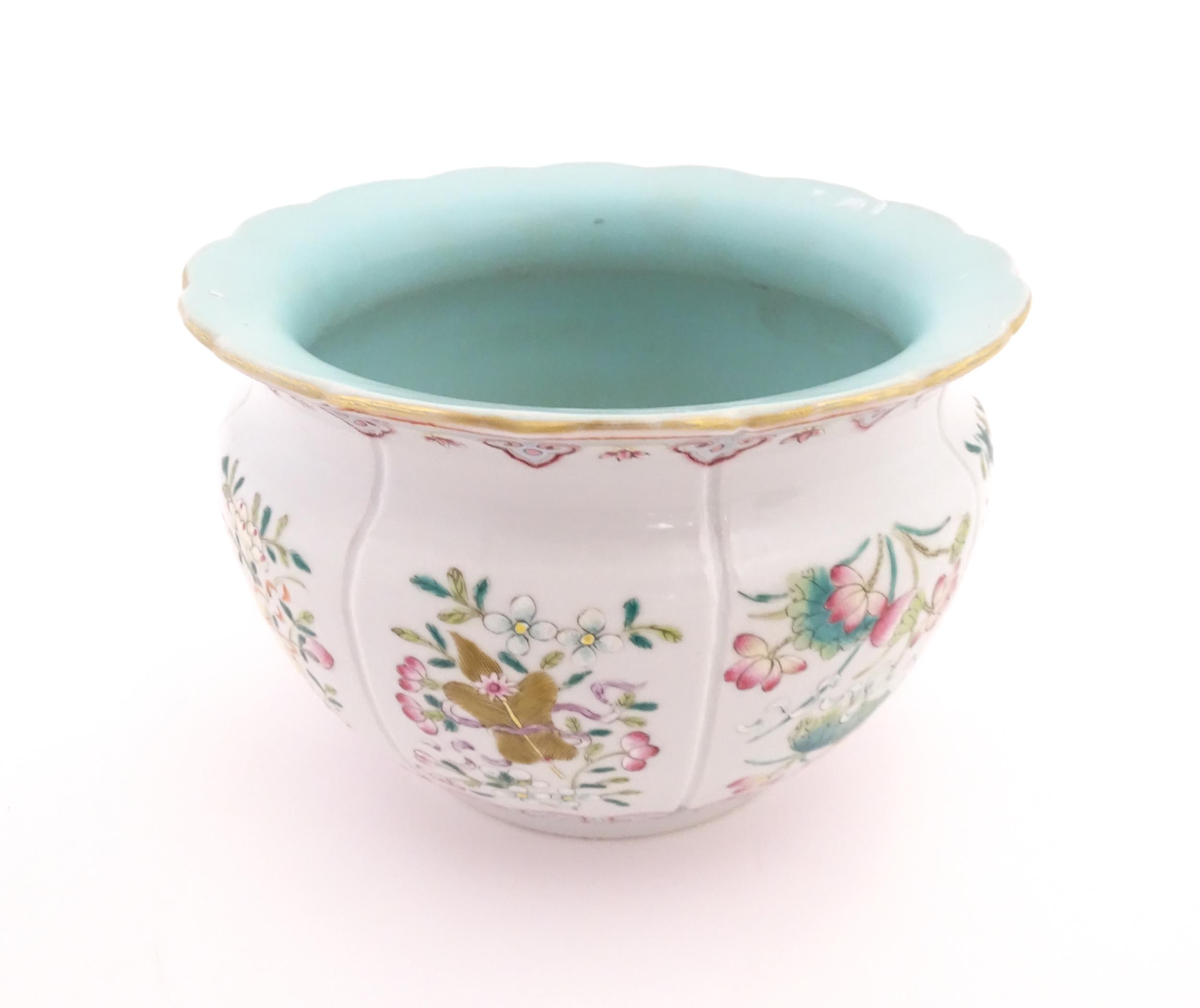 A Chinese famille rose bowl with scalloped edge decorated with flowers, foliage and scrolls. - Image 4 of 8
