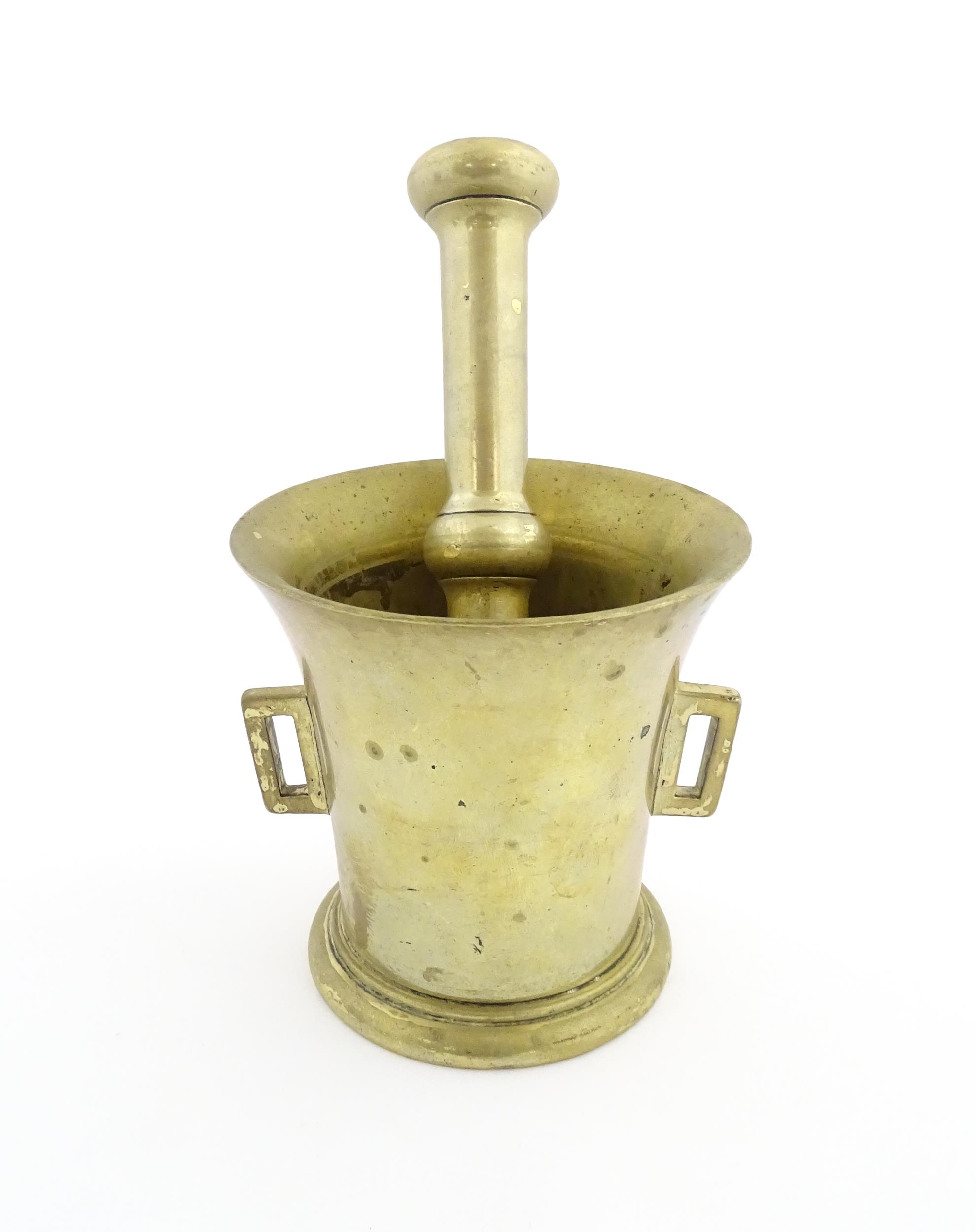 A 19thC brass pestle and mortar, the mortar of tapering form with twin rectangular handles. Mortar - Image 5 of 14