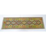 Carpet / Rug : A Turkish Anatolian kilim rug / runner with repeating geometric motifs. Approx. 34" x