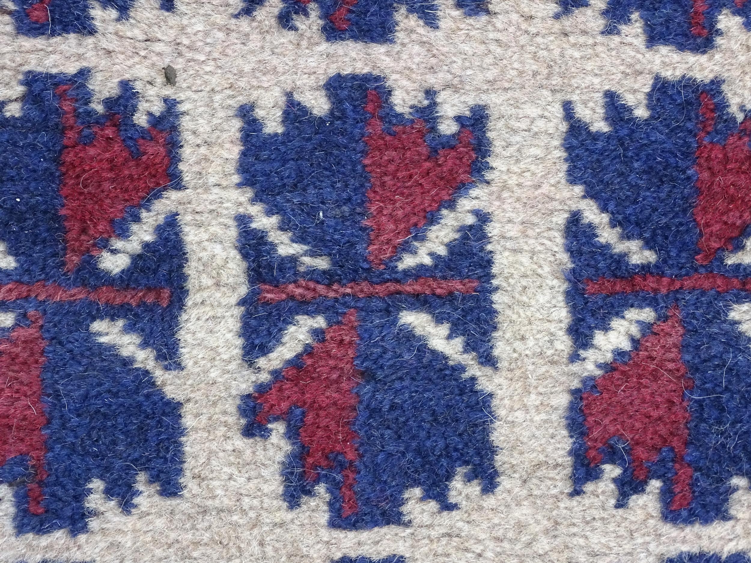 Carpet / Rug : A red, blue and cream ground rug with repeating geometric motifs. Approx. 55" x 29" - Image 5 of 7