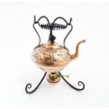 An Arts & Crafts Henry Loveridge & Co. copper kettle with copper and brass burner and cast iron