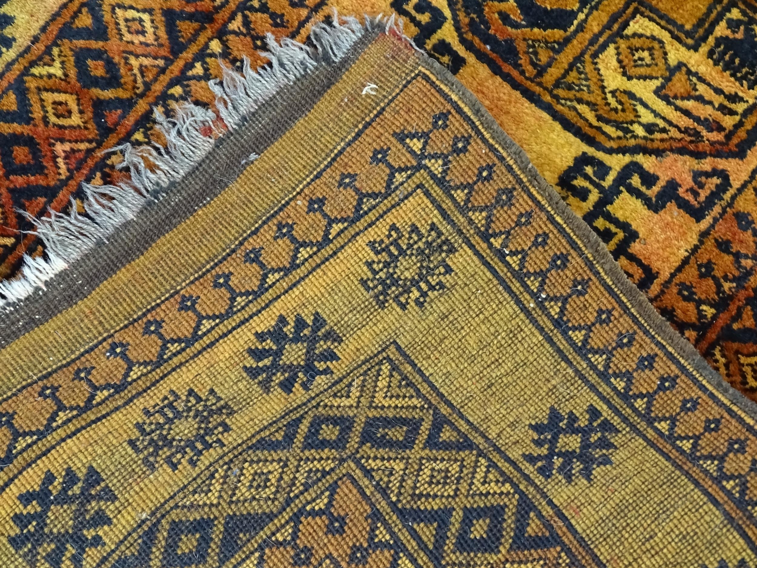 Carpet / Rug: An ochre ground rug decorated with centre vignettes with geometric motifs, further - Image 2 of 6