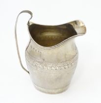 A Geo III silver cream jug, hallmarked London 1798 maker John Merry. Approx 4 1/2" high Please