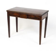 A late 18thC mahogany card table with a crossbanded, moulded fold over and revolving top raised on