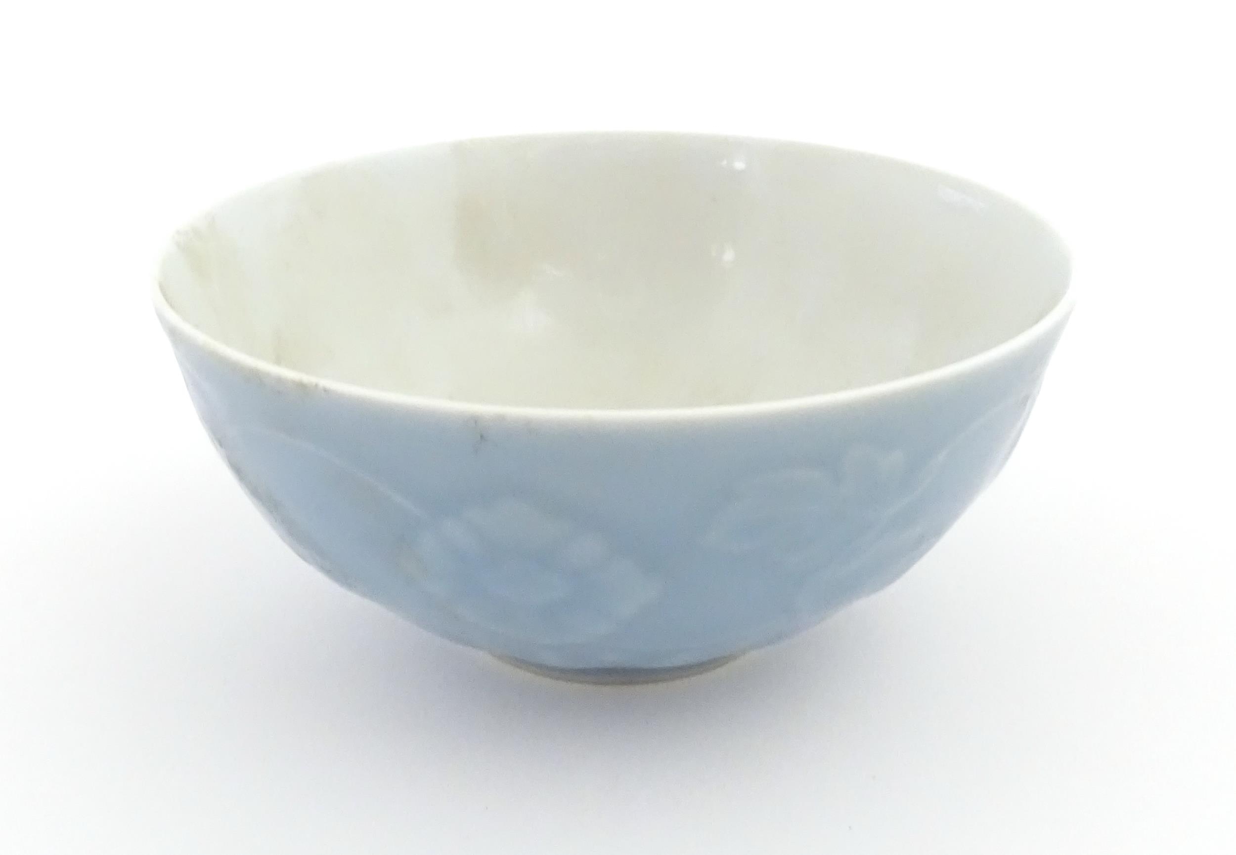 A Chinese bowl with a blue ground decorated with flowers and petals. Character marks under. - Image 3 of 8