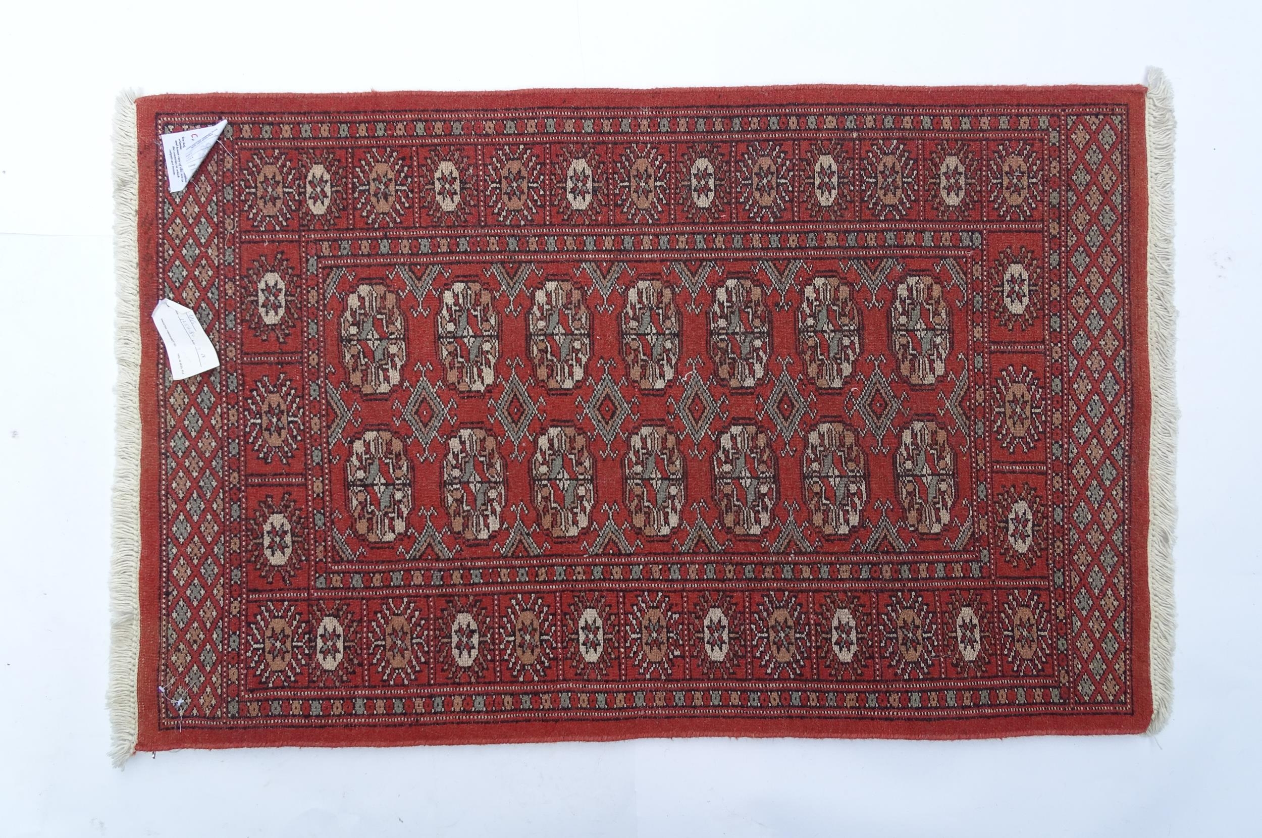 Carpet / Rug : A Pakistan wool red ground rug decorated with repeating geometric motifs with further - Image 8 of 8