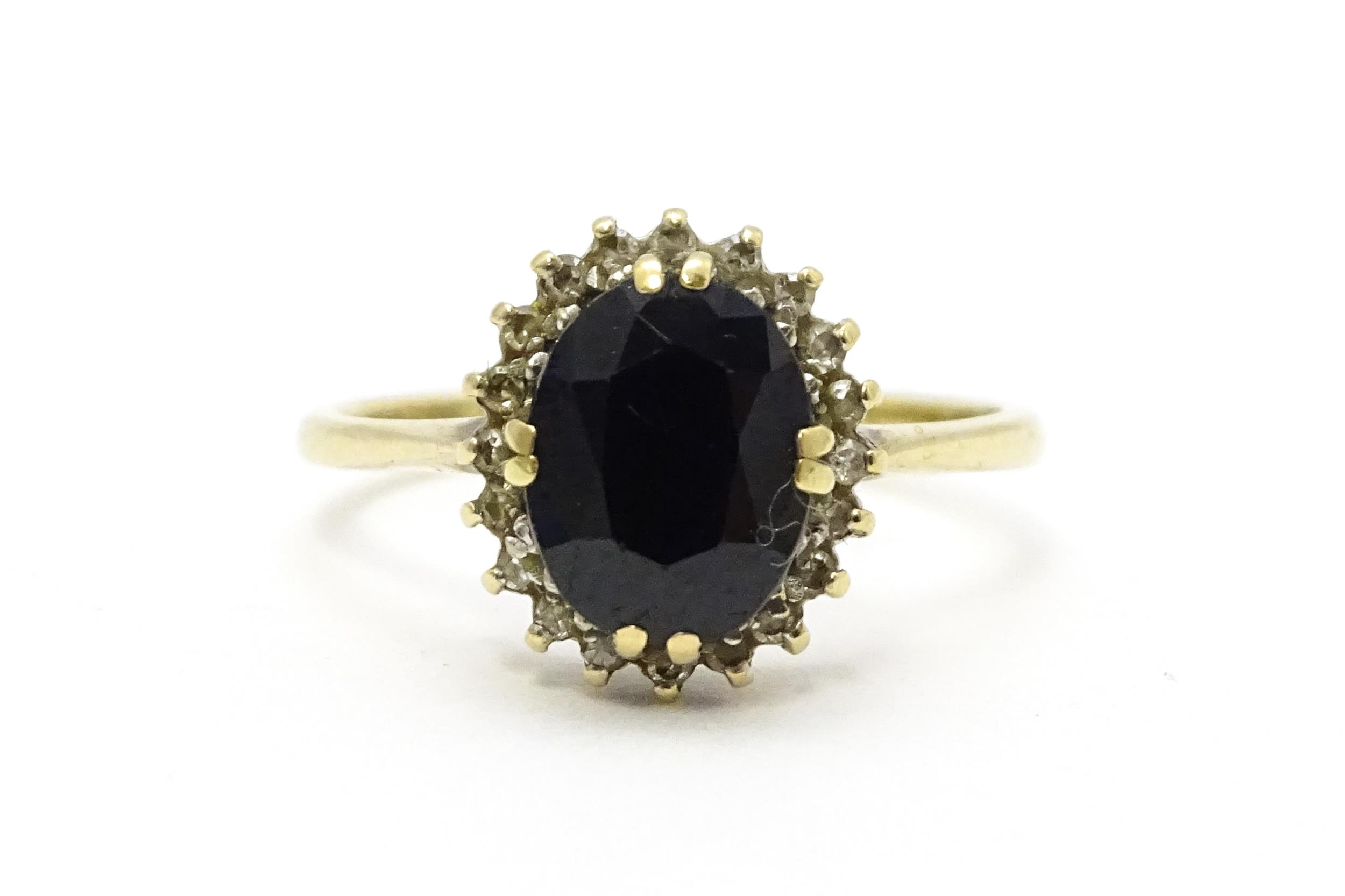 A 9ct gold ring set with central sapphire bordered by diamonds. Ring size approx. P Please Note - we - Image 3 of 6