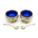 A pair of Victorian silver salts with blue glass liners, hallmarked London 1876, maker John Septimus