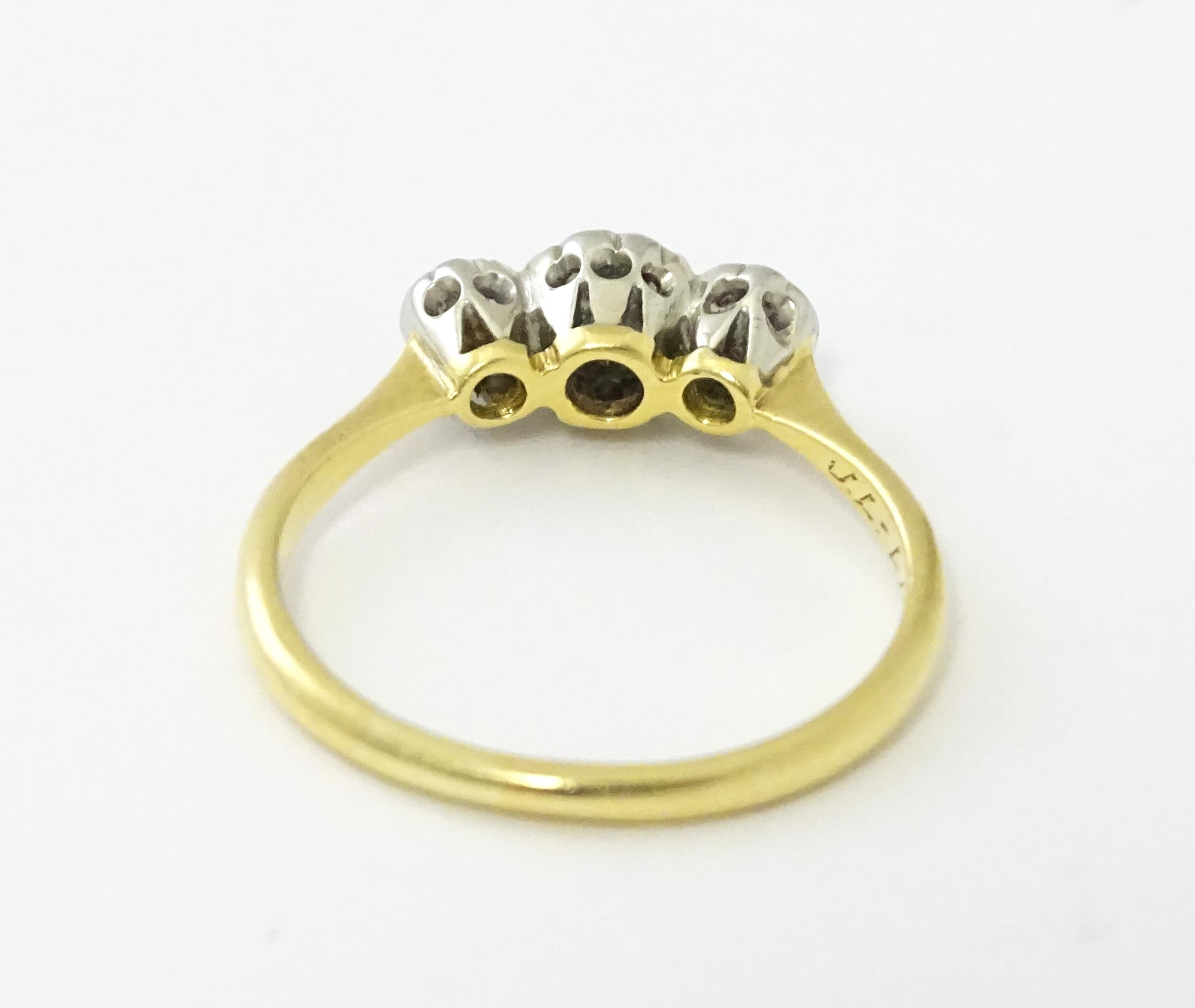 An 18ct gold ring with three platinum set diamonds. Ring size approx. O Please Note - we do not make - Image 10 of 18
