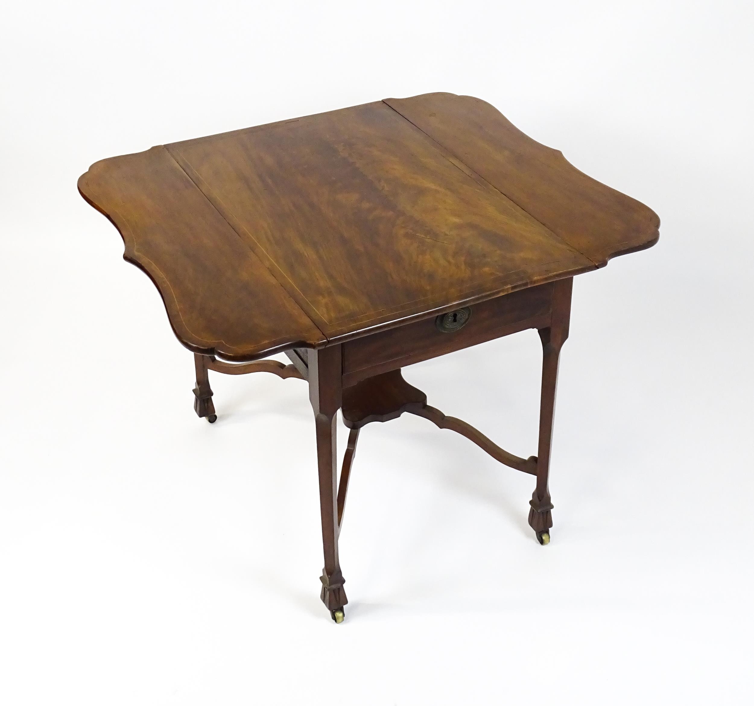 A late 18thC Chippendale style mahogany Pembroke table, the butterfly table top having two shaped