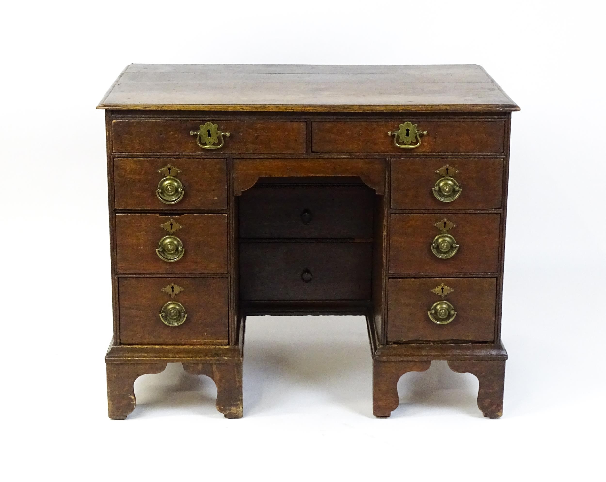An early / mid 18thC oak kneehole desk with a moulded top above two short drawers and two banks of - Image 5 of 10