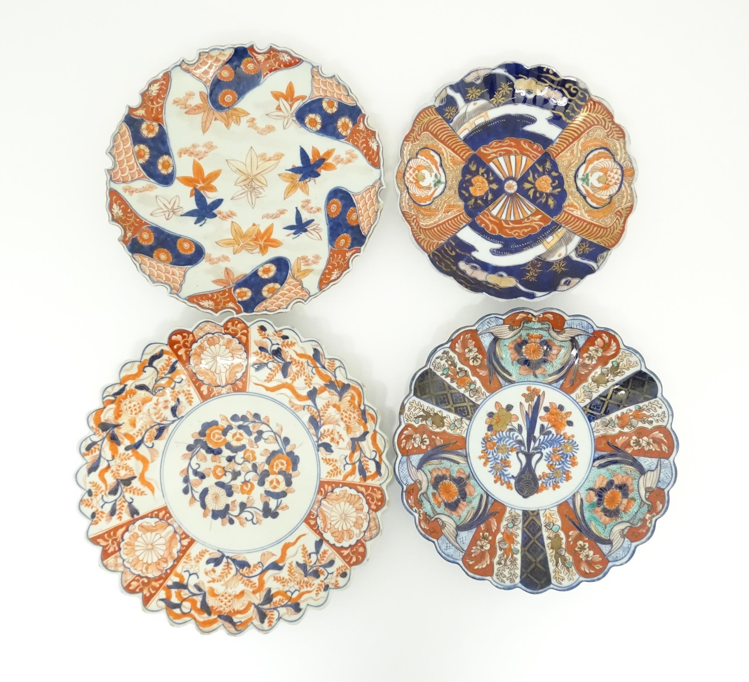 Four Japanese chargers with shaped edges decorated in the Imari palette with flowers, foliage and - Image 3 of 7