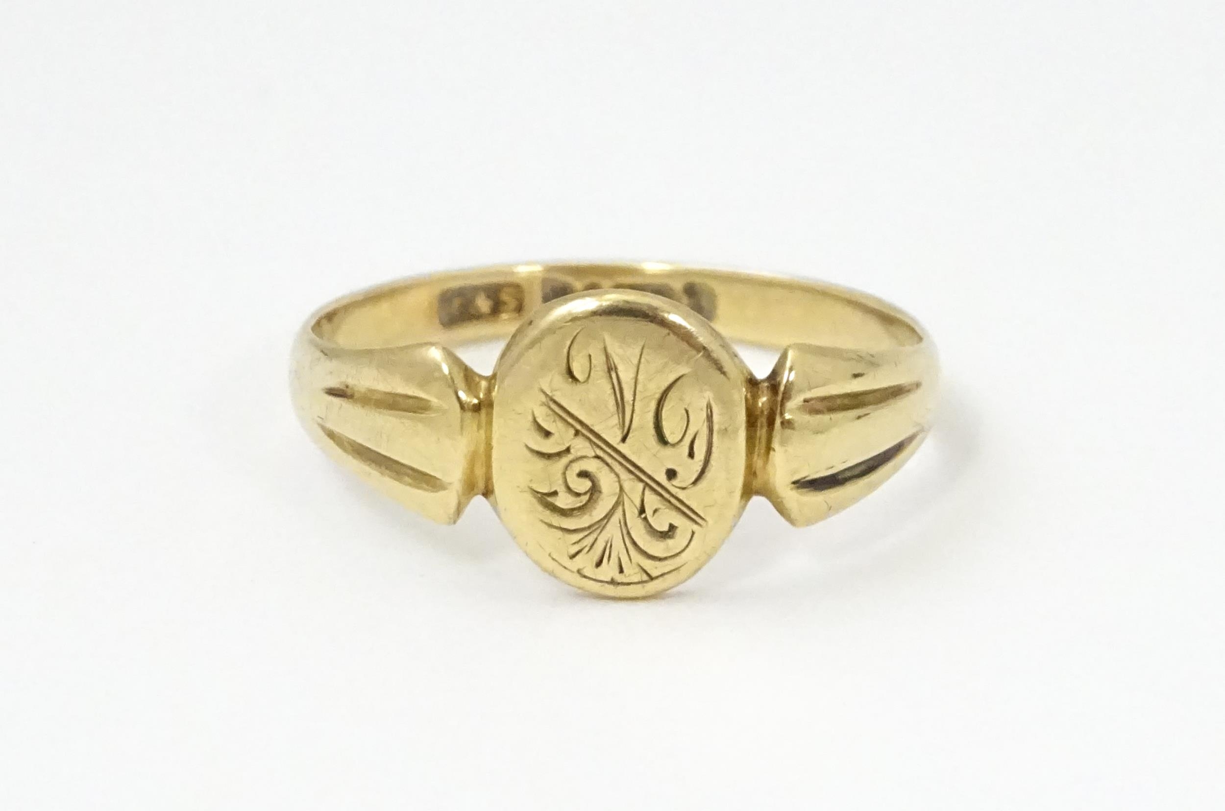 A 9ct gold ring with engraved detail to centre. Ring size approx. N Please Note - we do not make