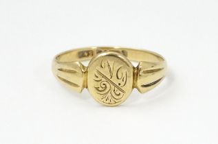 A 9ct gold ring with engraved detail to centre. Ring size approx. N Please Note - we do not make