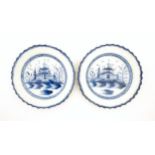 A pair of Liverpool blue and white pearlware plates with feathered edge decorated with a lake