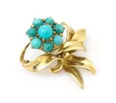 A 9ct gold brooch of floral form with turquoise detail. By Bernard Instone (Langstone Silver