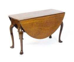 A late 18thC mahogany drop leaf table, opening to form an oval dining table and raised on four