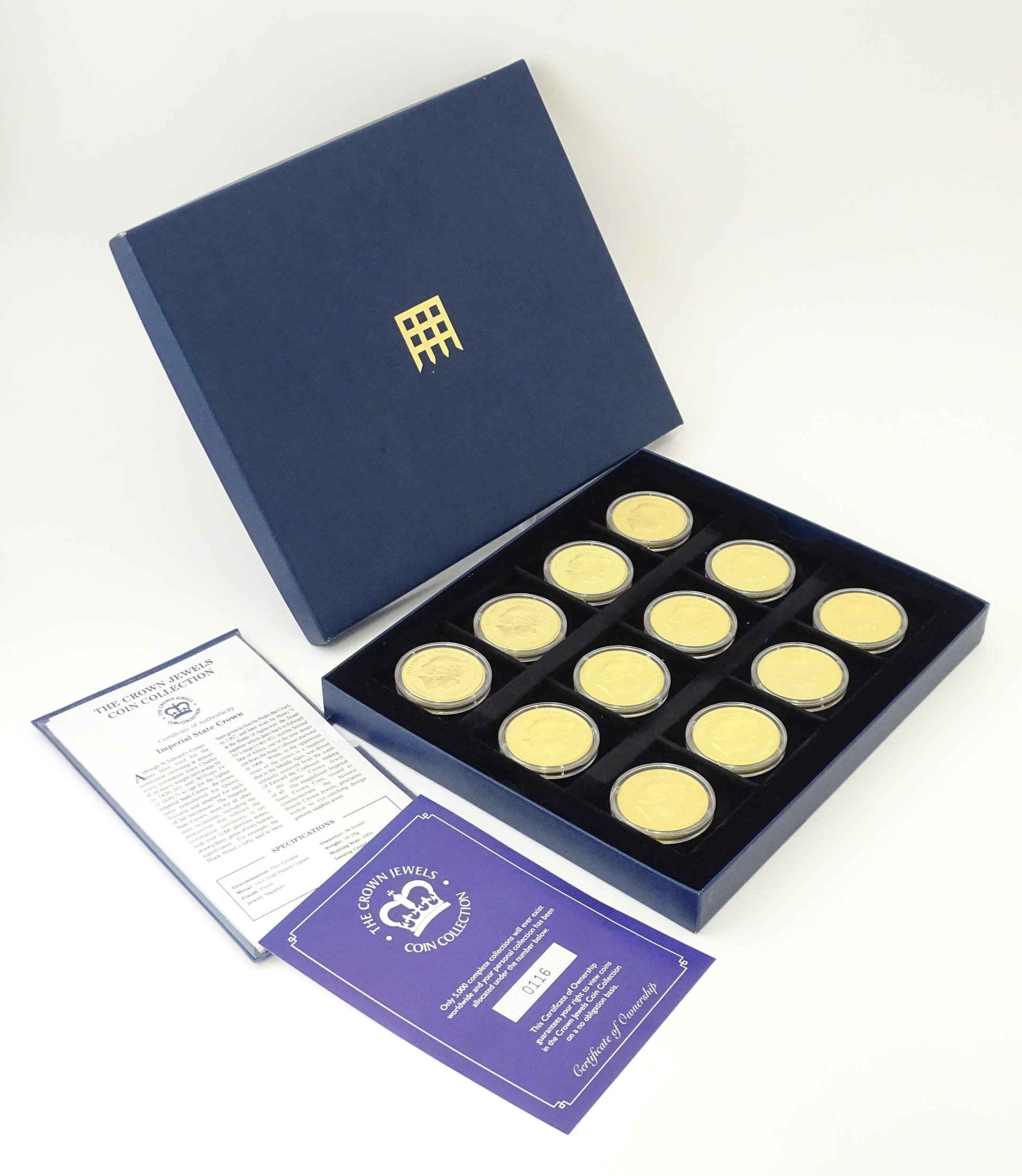 Coins: A boxed set of twelve Westminster Mint gold plated medallions titled the Crown Jewels Coin