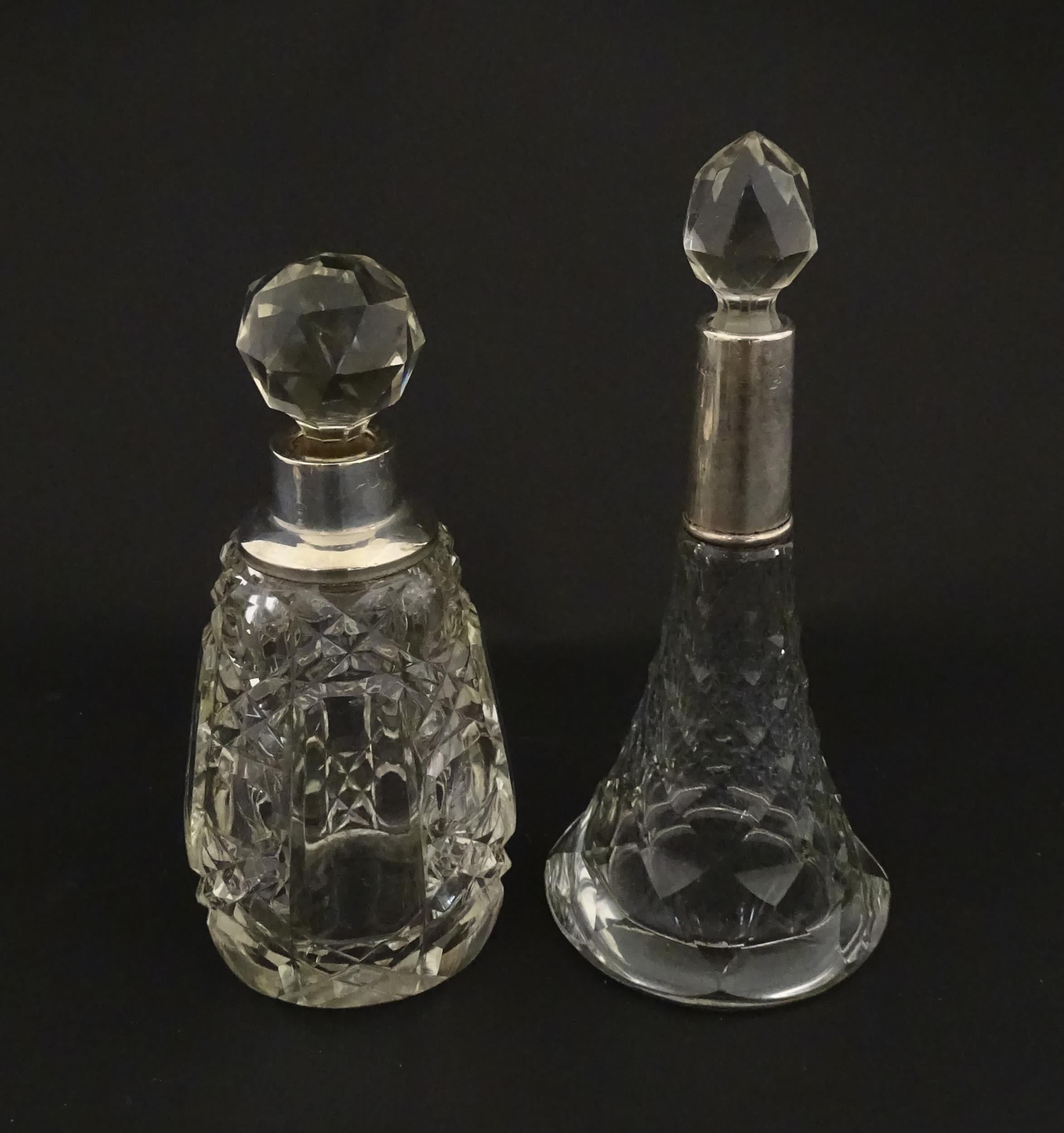 Two cut glass scent / perfume bottles with silver mounts, one hallmarked Birmingham 1921, maker A