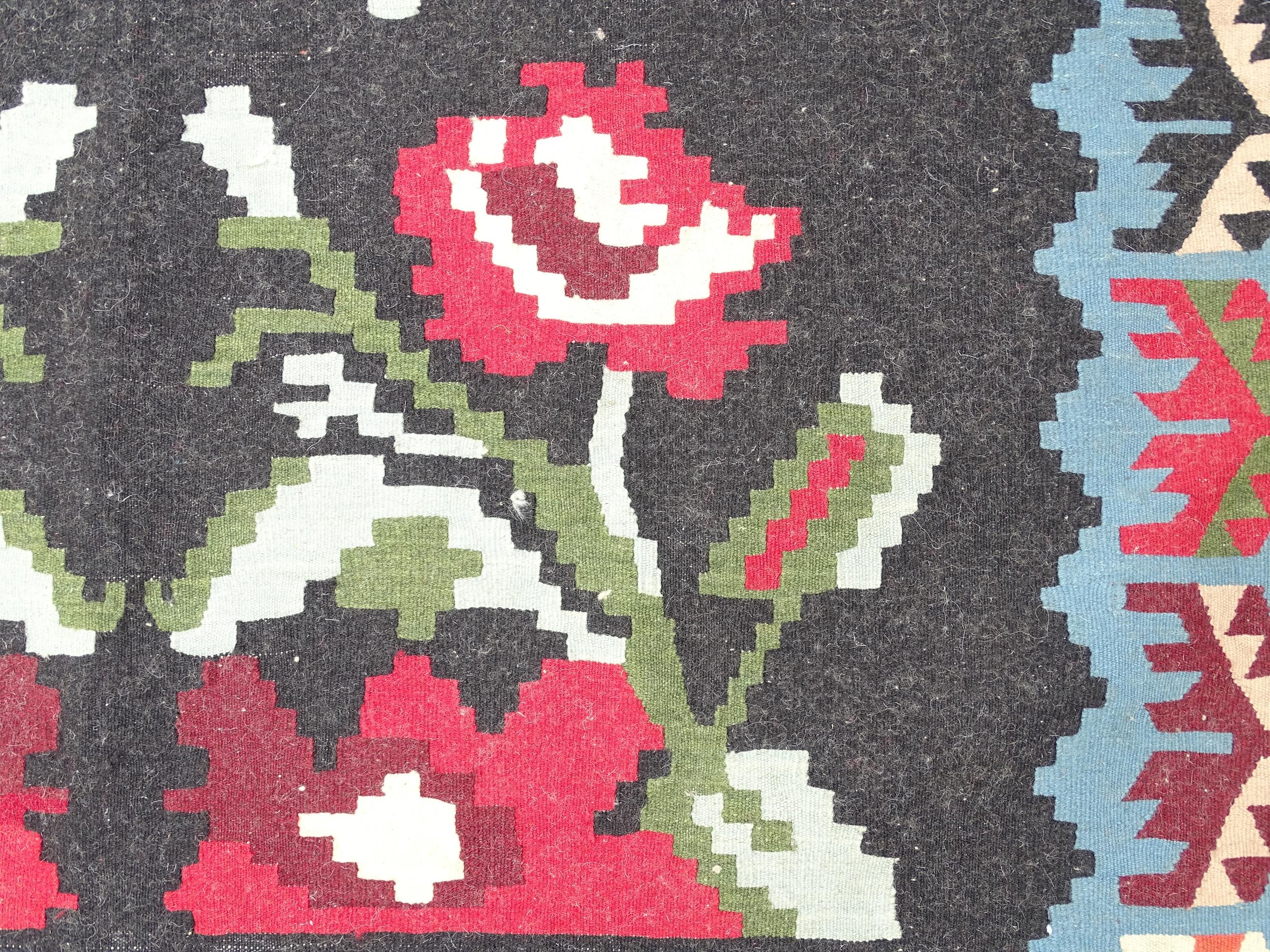 Carpet / Rug : A black ground rug with red floral decoration, with geometric motifs to borders. - Image 9 of 9