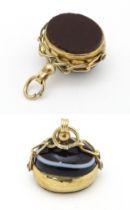 A 19thC 9ct gold pendant fob set with spinning bullseye agate and carnelian, hallmarked Chester.