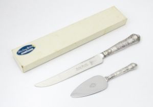 A boxed silver handled cake knife hallmarked Sheffield 1978 maker Harrison Brother together with a