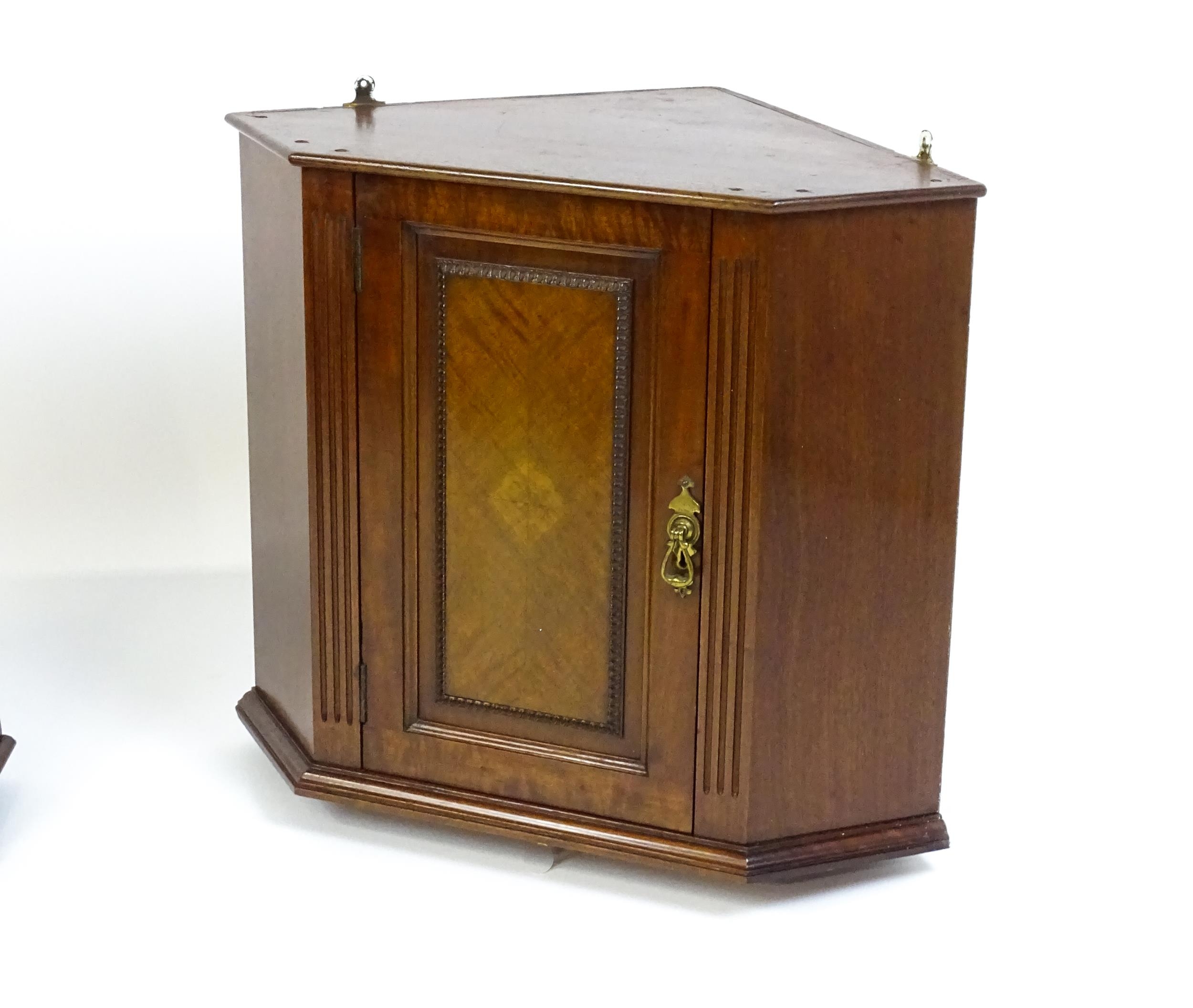 A pair of mid 20thC walnut corner cabinets. Bearing labels to back panels. 21 1/2 high x 26" wide - Image 3 of 7