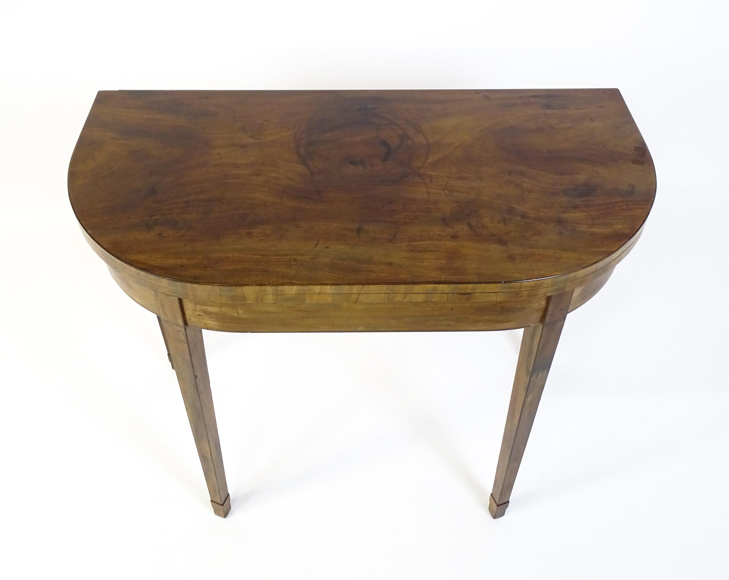 An early 19thC mahogany card table of demi lune form, the top opening to show a baize circular - Image 4 of 6