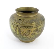 A Chinese cast brass pot decorated with phoenix, bat, stylised clouds, flowers, etc. Character marks