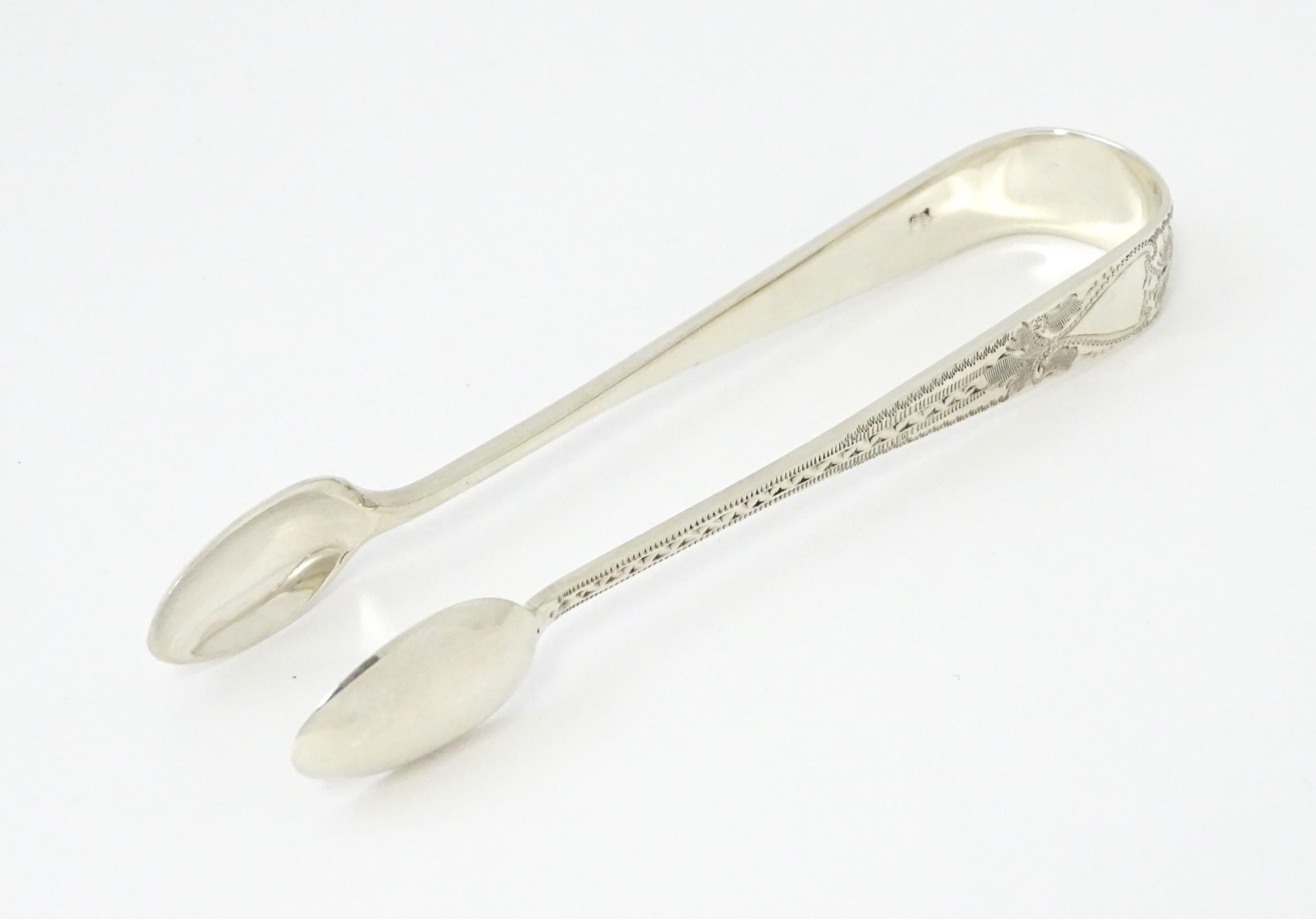 Silver sugar tongs with bright cut engraved decoration Hallmarked London 1901 maker Josiah