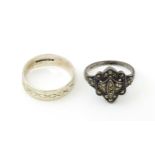 Two silver rings, one with engraved decoration, the other set with marcasite. Ring size approx. R (