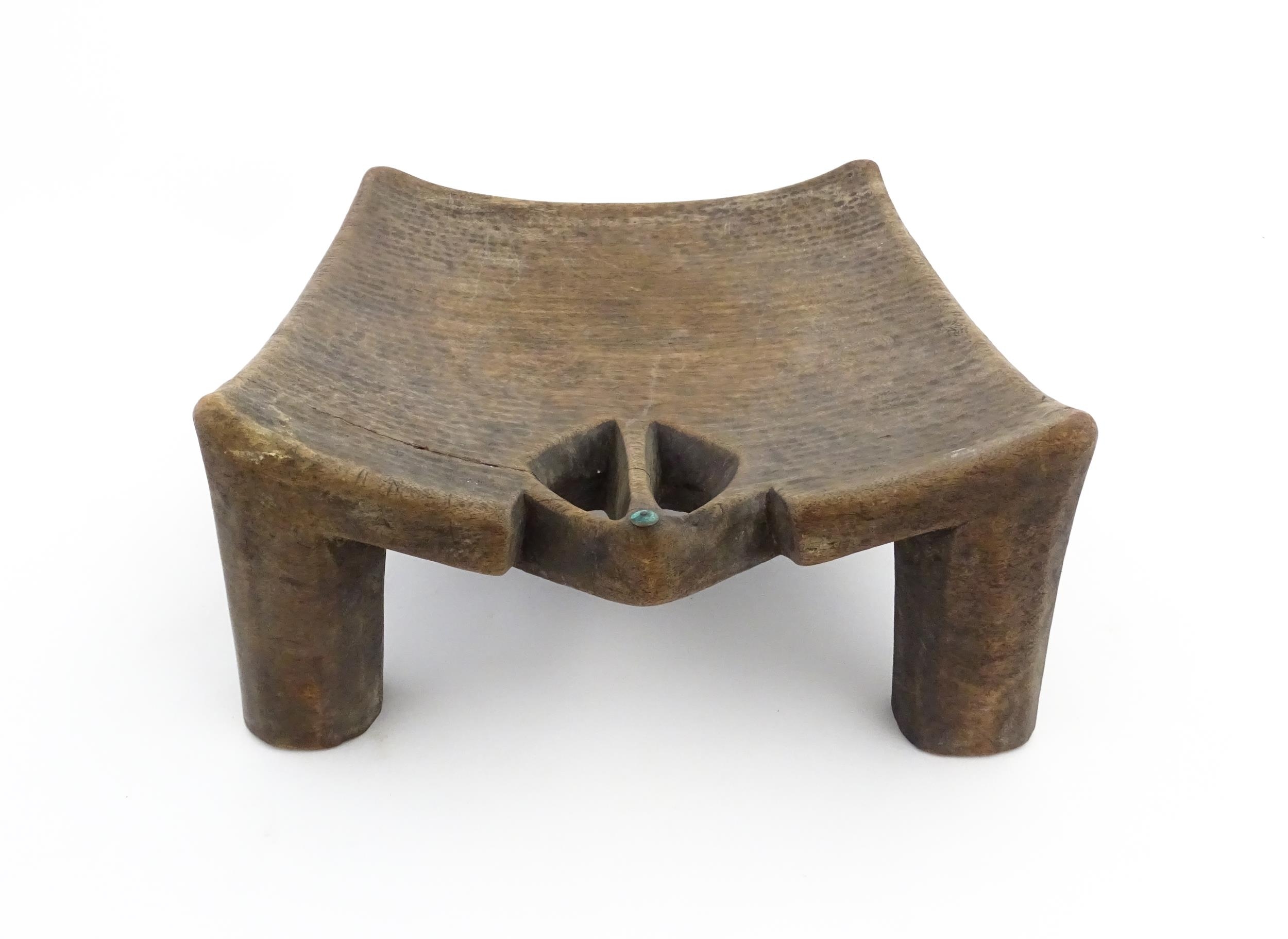 Ethnographic / Native / Tribal: An African carved wooden stool with pierced decoration, raised on - Image 4 of 7