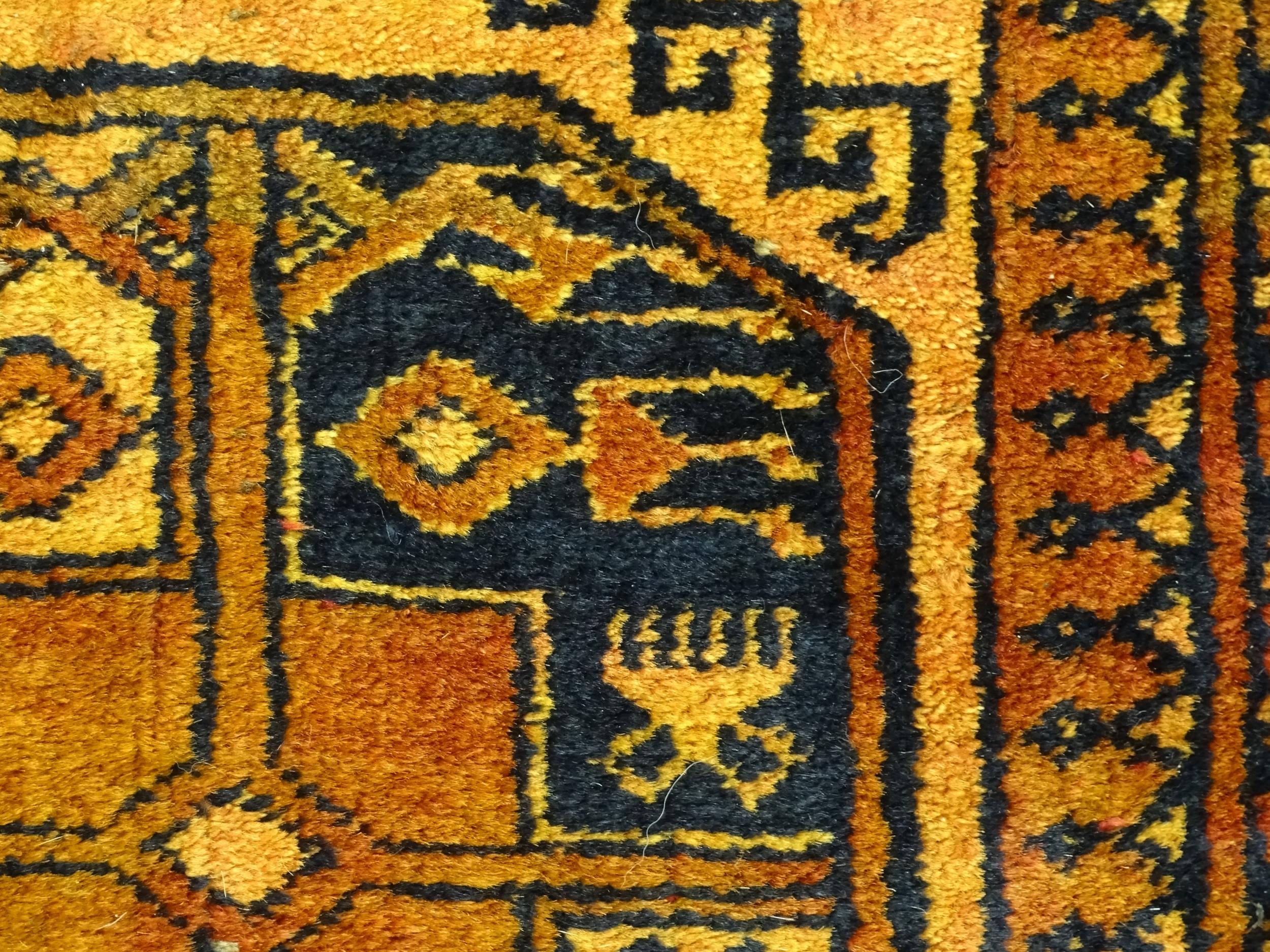 Carpet / Rug: An ochre ground rug decorated with centre vignettes with geometric motifs, further - Image 6 of 6