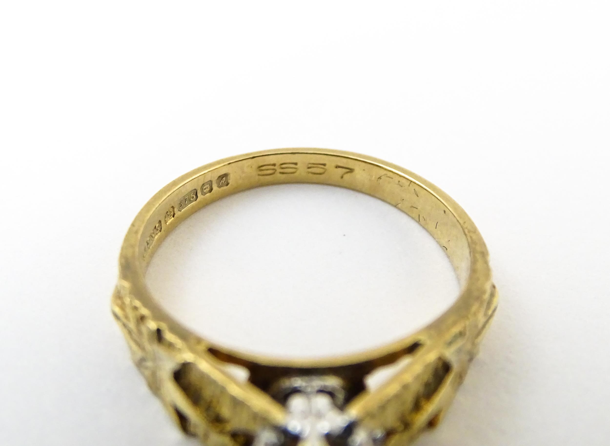 A 9ct gold ring set with central illusion set diamond with star detail to shoulders. Ring size - Image 2 of 7