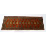 Carpet / Rug : A North West Persian Senneh runner with a red ground decorated with central repeating